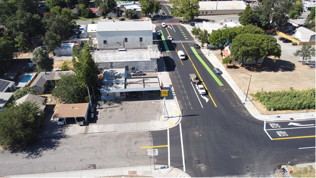 Aerial photo showing new green bicycle lane treatment as well as new textured crosswalks as part of the Yolo State Route 16 Esparto Improvements Project.