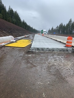 Photo showing the Central Truckee eastbound I-80 off-ramp that is in the process of being reconstructed. New concrete slabs are being poured segments at a time. 
