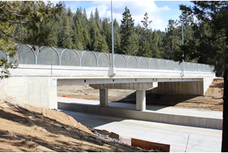 A newly reconstructed overcrossing on Interstate 80 in Placer County features mountain reliefs on the side, improved lighting and decorative wire fencing.