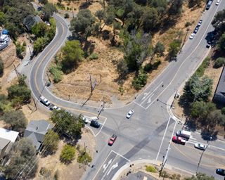Aerial drone image showing the intersection of State Route 49 at Lincoln Way and Borland Avenue in south Auburn. The intersection has a traffic signal, which will be replaced by a roundabout, in addition to reducing the sharpness of two roadway curves heading south into the canyon area. 