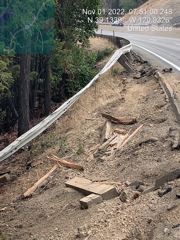 Damaged guardrail from a recent collision is shown along I-80 westbound near Secret Town. Chunks of wood litter the shoulder where the guardrail was damaged.