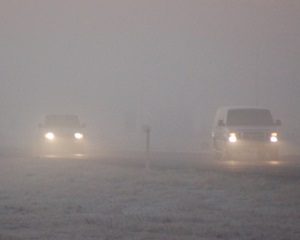 Two cars driving through fog visibility 