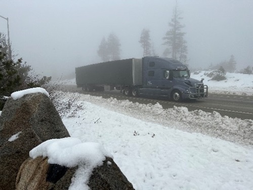 Image of Big rig truck driving through snow