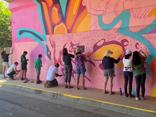 image of group painting the wall 