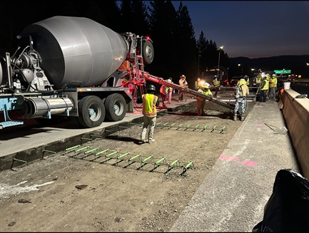 Crews pour new concrete slab along Interstate 80 in the Sierra Nevada