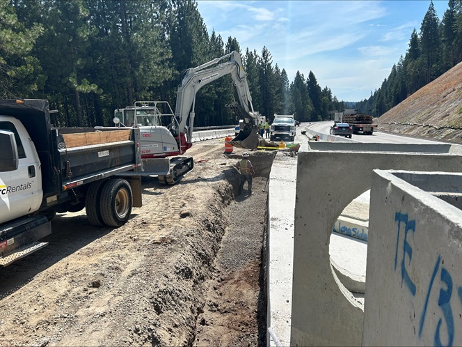 Crews preparing trench for underground drainage facilities along Interstate 80.