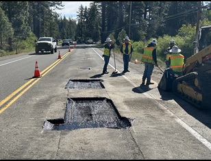 Construction crews performing patch paving as part of a Middle Mile Broadband Network installation project along State Route 28.