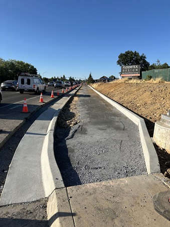 Excavated gravel along State Route 49 in Auburn, prepped and ready for fresh concrete as part of a sidewalk gap closure project.