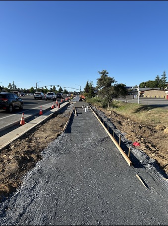 Excavated gravel along State Route 49 in Auburn, prepped and ready for fresh concrete as part of a sidewalk gap closure project.