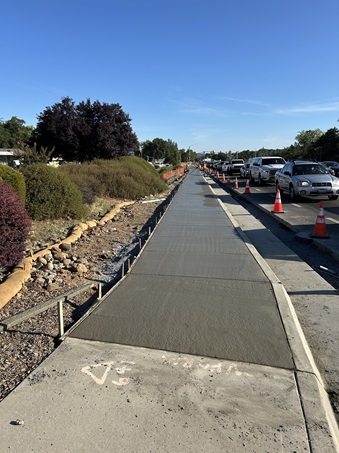 Freshly poured concrete along State Route 49 as part of a sidewalk gap closure project in Auburn.