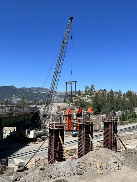 Construction crews making preparations for the installation of concrete girders for the new eastbound bridge along Interstate 80 at the junction with State Route 20 in the Sierra Nevada.