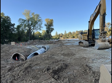 Construction equipment alongside State Route 49 as crews work on a safety barrier and roundabout project.