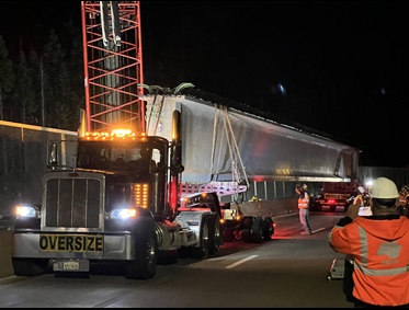 Concrete girder on big rig truck waiting for crews to install along the new eastbound bridge span of the Yuba Pass Separation Overhead Bridge along Interstate 80 in the Sierra Nevada.