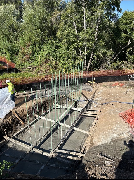 Freshly poured concrete footings for the new pedestrian bridge over Rock Creek along State Route 49 in Auburn as part of a sidewalk gap closure project.