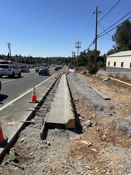Freshly poured concrete curb and gutter along State Route 49 in Auburn as part of a sidewalk gap closure project.