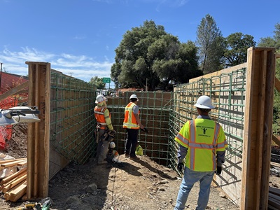 Construction crews installing reinforcement and forms for the abutments and wing walls for the new Rock Creek Pedestrian Bridge along State Route 49 in Auburn.