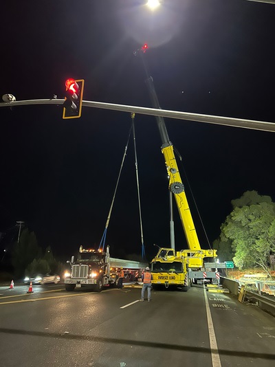 Crews delivering concrete girders for the new pedestrian bridge over Rock Creek along State Route 49.