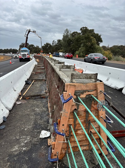 New concrete barrier under construction along State Route 49 in Placer County near Auburn.