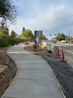 Freshly poured concrete along State Route 49 as part of a sidewalk gap closure project in Auburn.