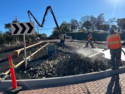 Crews adding cobble stone to the newly constructed roundabouts along State Route 49 in Placer County.