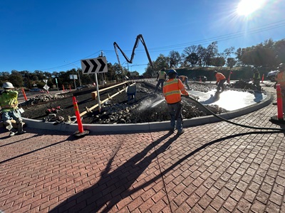 Crews adding cobble stone to the newly constructed roundabouts along State Route 49 in Placer County.