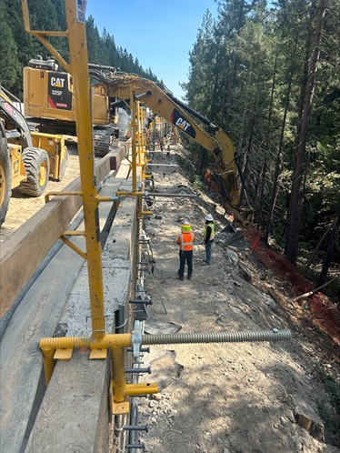 Crews preparing the bottom of the newly installed retaining wall that allows extra room for the new eastbound truck climbing lane along Interstate 80.