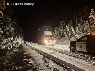 Semi-trucks stuck on snow covered road in rural area of Sierra County, image courtesy CHP Grass Valley.
