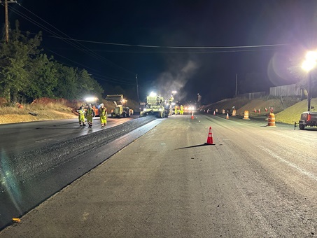 Crews laying down fresh asphalt along State Route 49 near Lone Star Road in Placer County as part of a safety barrier and roundabout project.