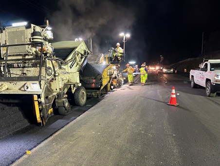 Crews laying down fresh asphalt along State Route 49 near Lone Star Road in Placer County as part of a safety barrier and roundabout project.