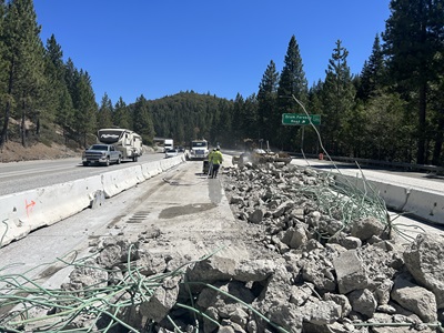 Crews removing the old median barrier and concrete pavement along Interstate 80 in the Sierra Nevada, allowing room for the new eastbound truck climbing lane.