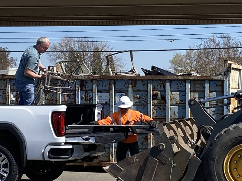 Image of Caltrans employee assisting local community member during local Caltrans Dump Day.