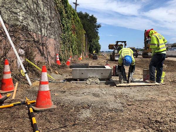 Construction crews installing a new stormwater drainage system