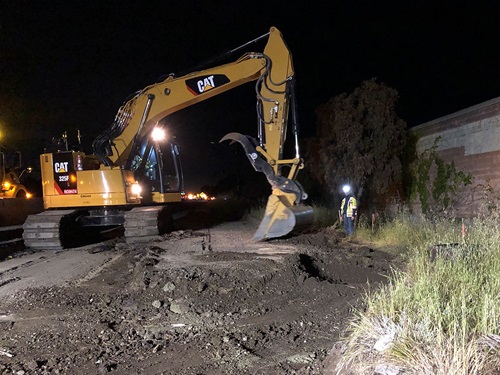 Construction crews excavating on the freeway shoulder on 101