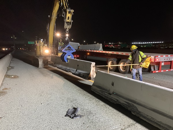 2021-05-07 Construction crews placing temporary concrete barriers
