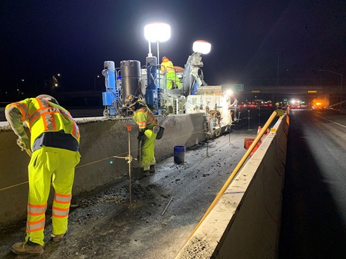 Construction crews working to remove the old median barrier