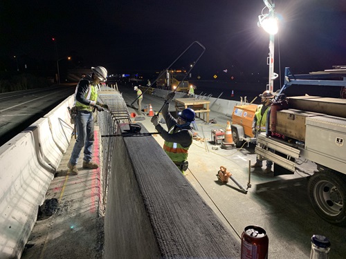 Construction crews placing rebar in the freeway median