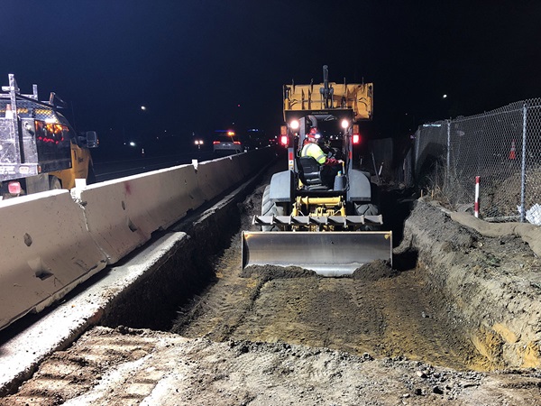 Construction crews leveling a section of future roadway