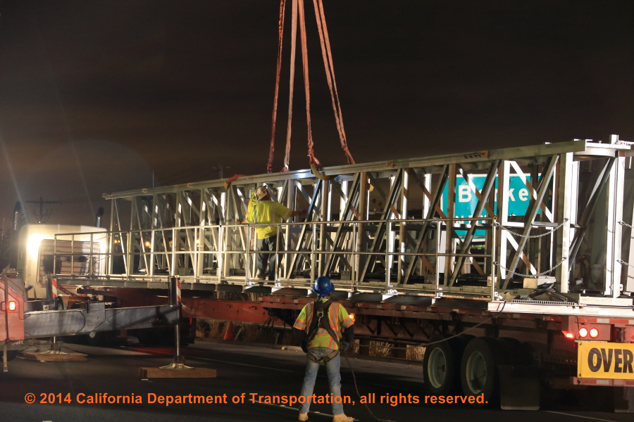 A photograph of a sign bridge being installed for a different project.
