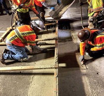 Crews finish pouring concrete for the final joint on the upper deck of the RSR Bridge