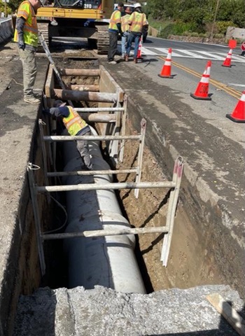 Photograph of Caltrans performing sinkhole repair work in a trench along State Route 131 in Marin County.