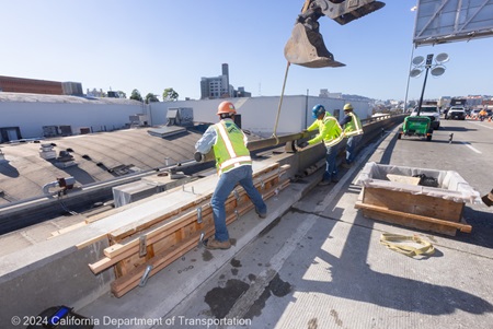 Caltrans crew working on emergency barrier rail repairs on the Central freeway connector ramp from southbound US-101 to southbound US-101 Central Freeway as part of the Emergency Barrier Repair Project. 