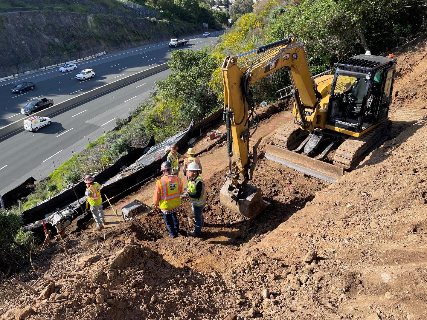 Caltrans crew with an excavator working on a slop on US 101 just south of the Francisco Boulevard on-ramp in San Rafael where Caltrans will continue storm related slope protection project.
