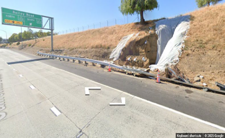 Tarps cover a section of grassy slope behind a damaged railing along eastbound State Route 4 near the Bailey Road exit in Contra Costa County.