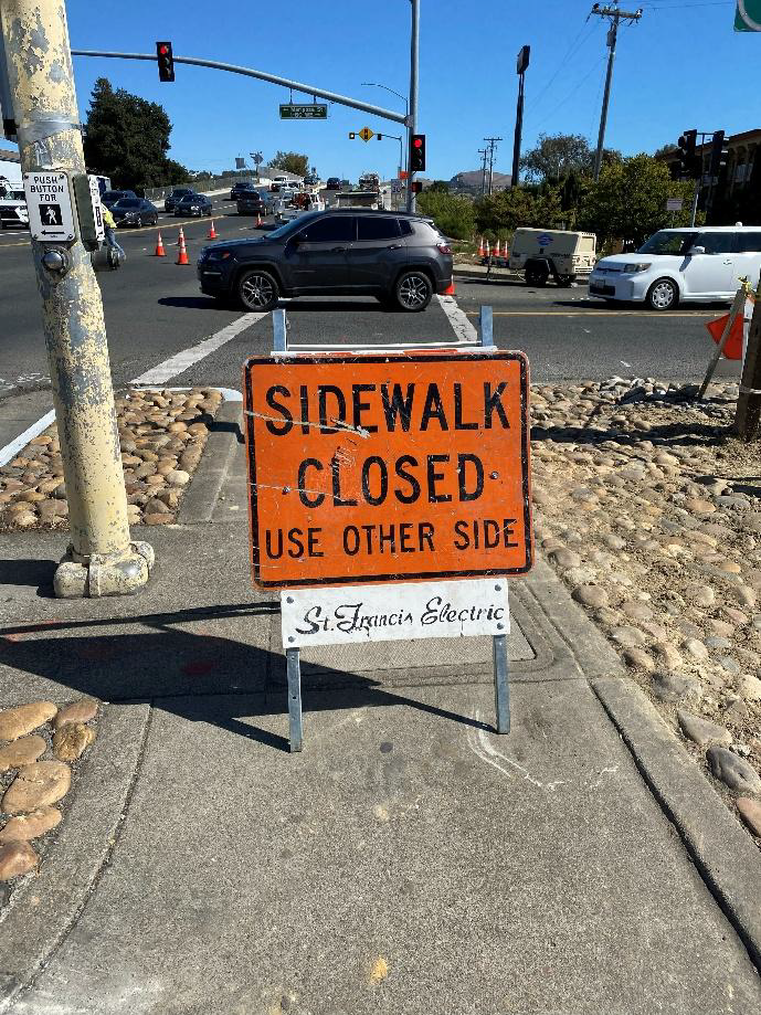 Pedestrians are directed to utilize the crosswalk on the other side of the road via signage barricades on the sidewalk for daytime single lane closure on State Route-29 between Ryder St and Arkansas St.