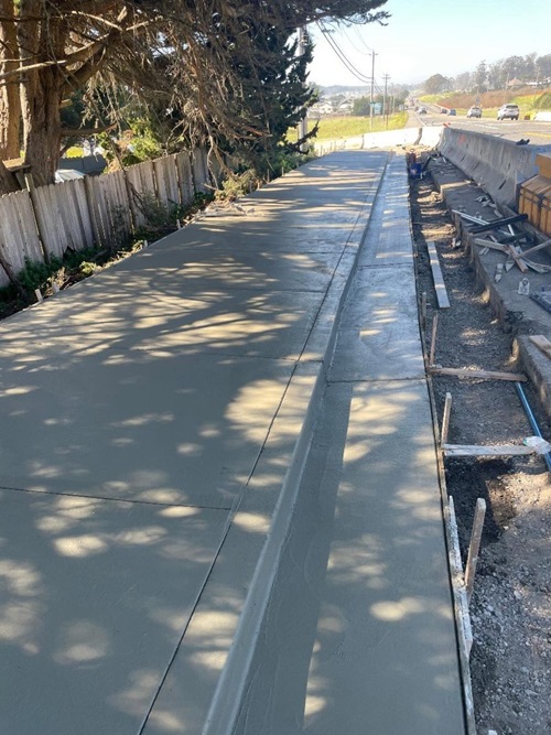 New concrete sidewalk on State Route 1 at Medio.