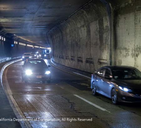 Two lanes of traffic travel through the Caldecott Tunnel between Contra Costa and Alameda Counties.