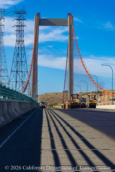 Heavy equipment smooths new pavement on the Carquinez (Alfred Zampa Memorial) Bridge.