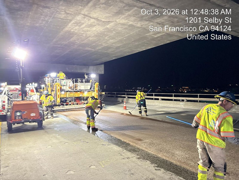 Caltrans crew using heavy equipment to place new polyester concrete as part of the I-280 Rehabilitation and Pedestrian Overcrossing Project that involves installing a polyester concrete deck overlay to improve long‑term pavement durability and ride quality.