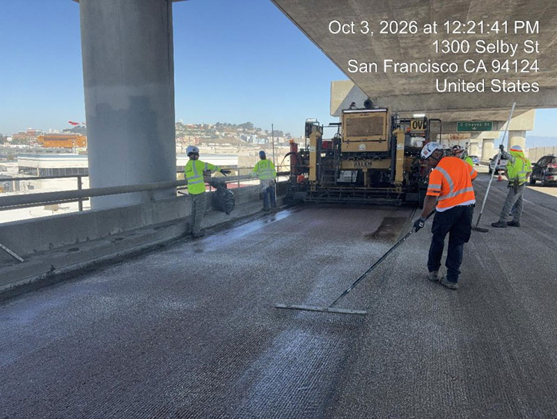 Caltrans crew using heavy equipment to place new polyester concrete as part of the I-280 Rehabilitation and Pedestrian Overcrossing Project that involves installing a polyester concrete deck overlay to improve long‑term pavement durability and ride quality.