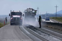 Trucks bring new paving material to be installed on westbound State Route 37 in Solano County on April 28, 2024.v
